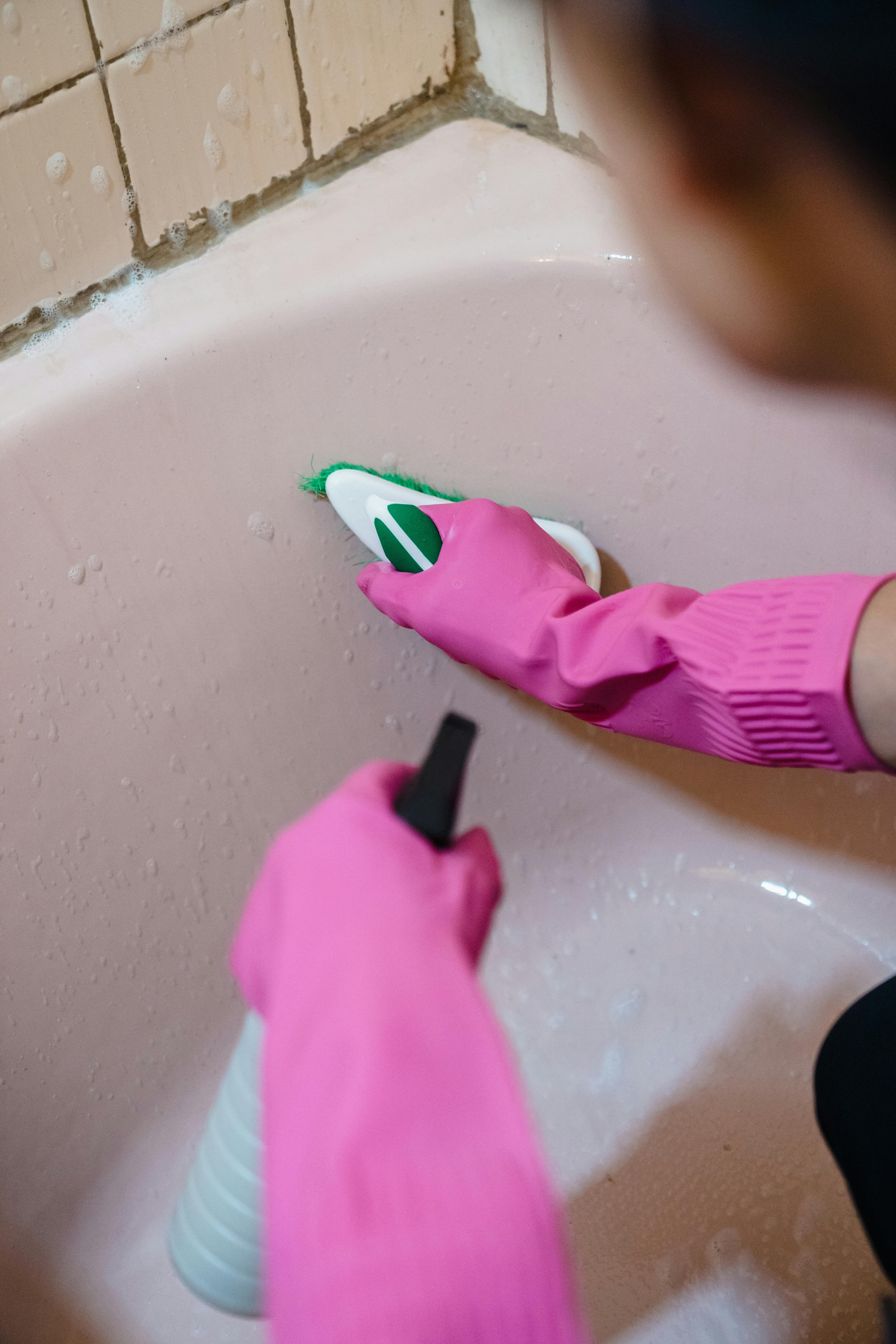 Cleaner scrubbing bathtub to hotel standard
