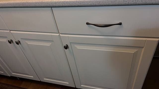 Spotless white kitchen cabinet fronts after standard clean