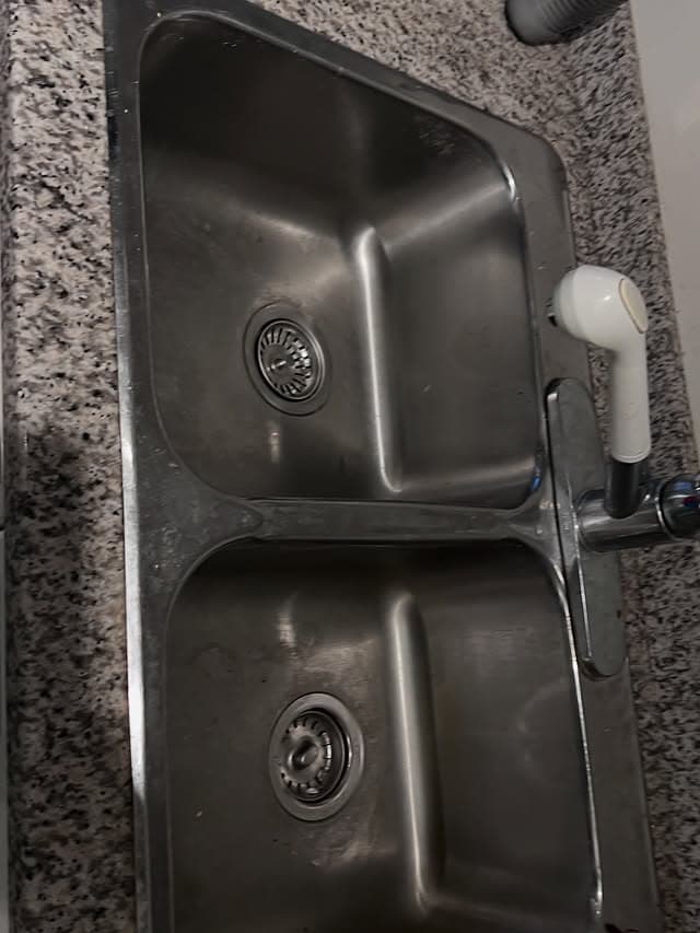 Gleaming stainless steel kitchen sink after standard clean