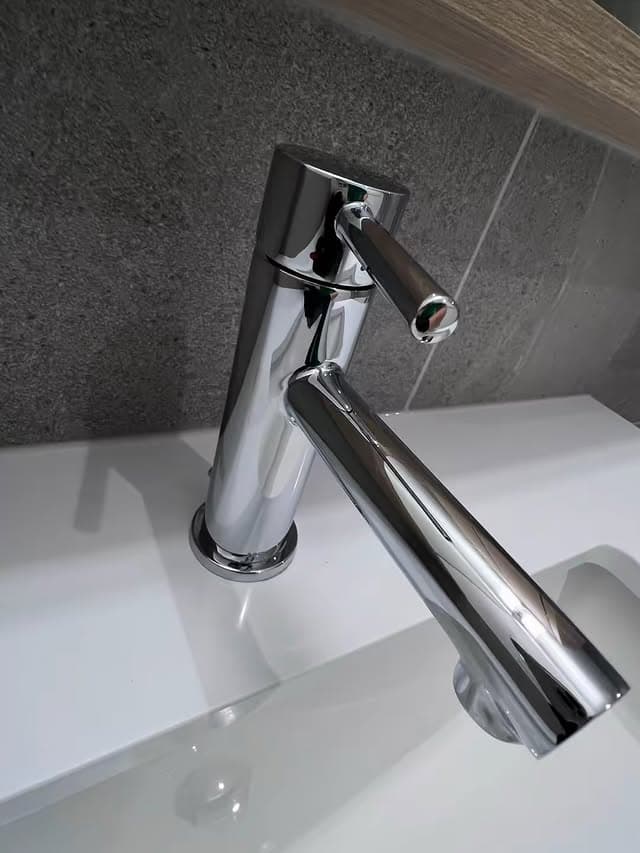 Polished chrome bathroom fixture after Maidless standard clean