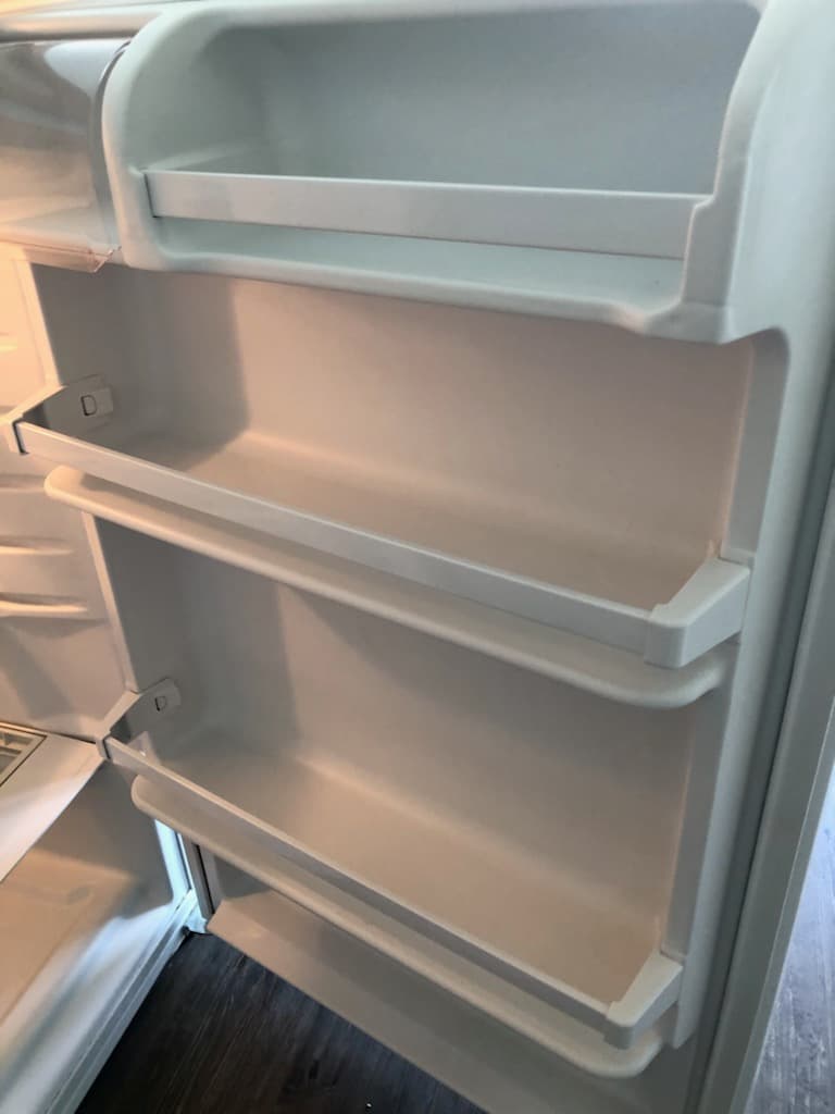 Fridge interior completely emptied and cleaned — what landlords inspect