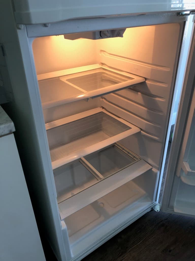 Fridge interior deep-cleaned — shelves and walls spotless